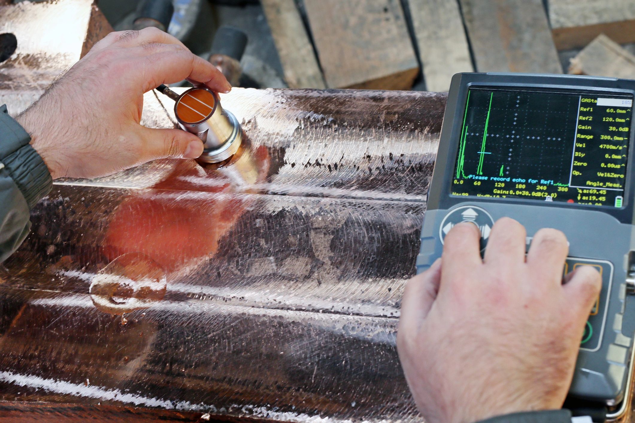 Inspector performing ultrasonic testing on industrial component