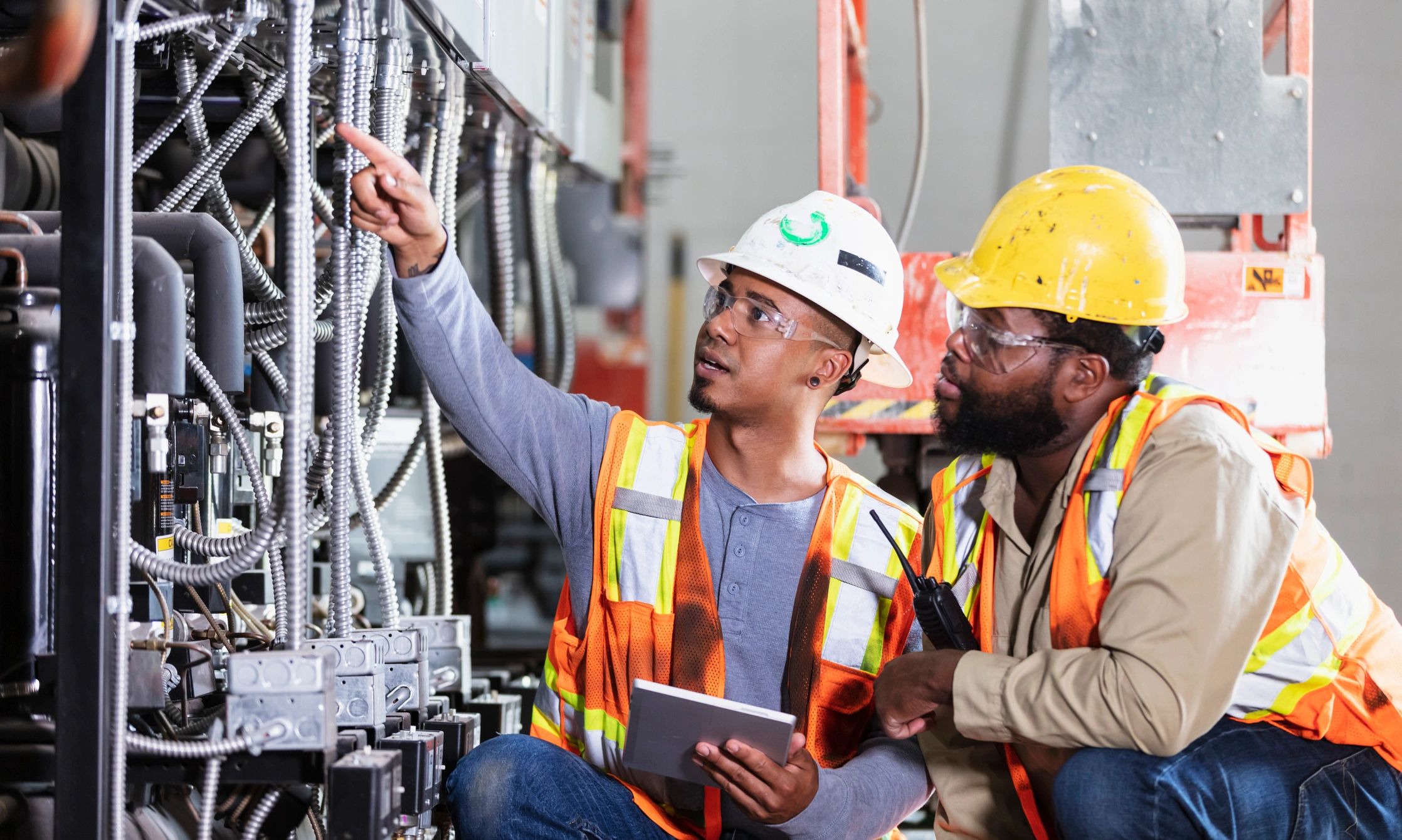Workers inspecting industrial equipment