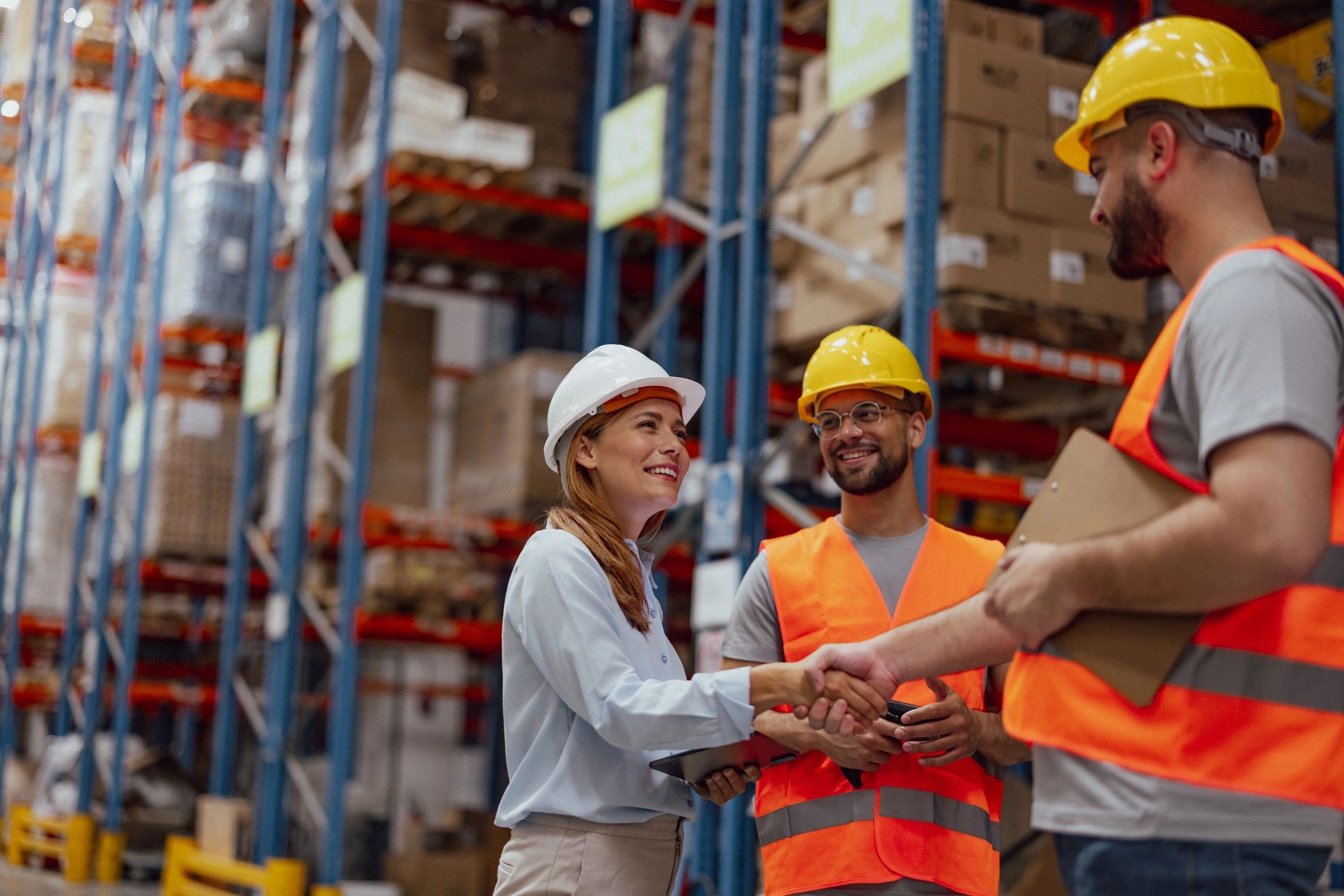 Client representative shaking hands with a manager in a warehouse