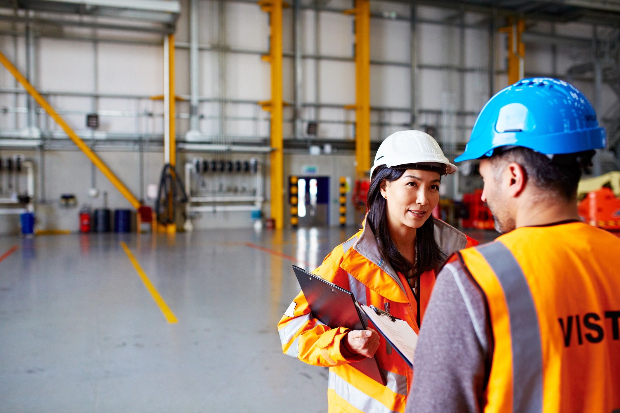 Two workers reviewing a clipboard in a warehouse
